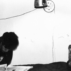 Bob B. looking through the real estate pages. I like the speaker just glued to the wall.