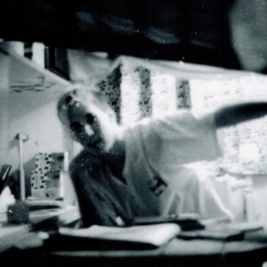 Jason C. in his room. He wedged the box spring in sideways and slept at a slight angle. Note the generic Sloane drapes.